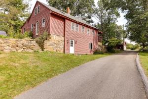 a red barn with a road in front of it at Cozy Exeter Vacation Rental with Grill and Fire Pit in West Greenwich