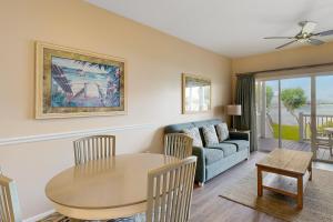 a living room with a table and a couch at Reef House in Duck Key