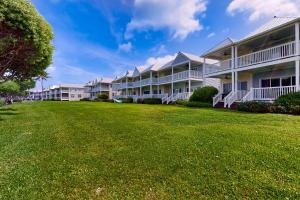 a row of apartment buildings with a large yard at Reef House in Duck Key