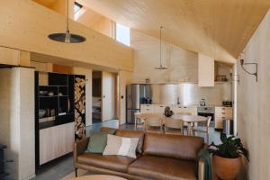 a living room with a couch and a table at Jacks Point Earth House, Mountain View & Fireplace in Frankton