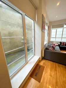 a living room with a large window and a couch at Euston flat in London