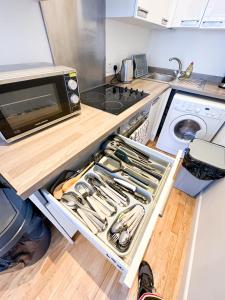 a kitchen with a drawer full of utensils at Euston flat in London