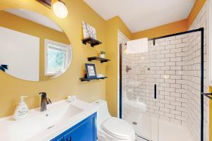 a bathroom with a sink and a toilet and a mirror at La Bella Vida at Bella Vista in Bella Vista +28 photos