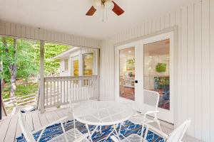 a patio with a table and chairs on a porch at La Bella Vida at Bella Vista in Bella Vista