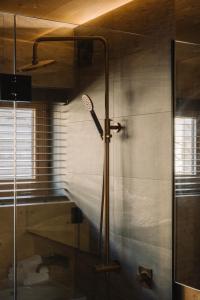 a shower with a tennis racket in a bathroom at Jacks Point - Earth House in Frankton