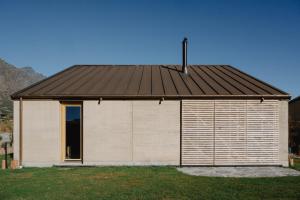 a large building with a brown roof at Jacks Point Earth House Escape in Frankton