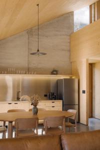 a kitchen and dining room with a table and chairs at Jacks Point - Earth House in Frankton Wharf