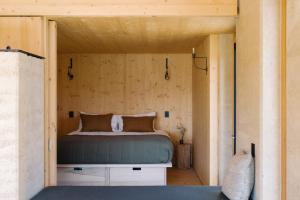 a bedroom in a tiny house with a bed at Jacks Point - Earth House in Frankton Wharf