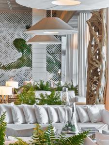 a living room with a white couch and plants at 1 Hotel South Beach in Miami Beach
