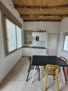 a kitchen with a table and chairs in a room at Ca Marinella in Combai