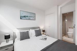 Säng eller sängar i ett rum på Bonbeach Bliss - Contemporary Waterfront Living