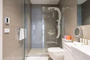 a bathroom with a shower and a toilet and a sink at 'Tides and Treasures' Unveil a Bonbeach Beachfront Bliss in Melbourne +12 photos