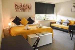 a hotel room with a bed and a couch at Studio for Professionals Trades Relocators in Cardiff