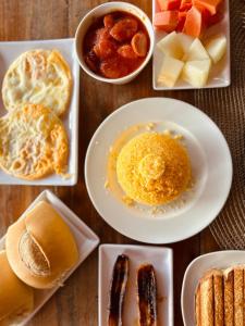 a table topped with plates of breakfast foods at Casa Flôr in Fernando de Noronha +29 photos