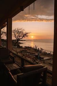 a view of a sunset from a beach with benches at La Casona de Lobitos - Cowork in Lobitos