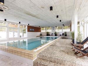 a large swimming pool in a building with a swimming poolvisorvisor at 6 person holiday home on a holiday park in Gilleleje in Gilleleje