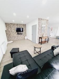 a living room with a couch and a tv at GuestHouse dos Limites in Espinho