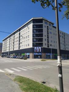 un gran edificio blanco al lado de una calle en Apartman Minja, en Subotica