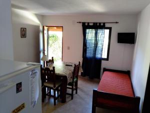 a kitchen and dining room with a table and chairs at Alma Mora in Merlo