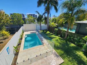 an overhead view of a swimming pool in a backyard at Classic Brisbane Queenslander with Pool & Yard in Brisbane