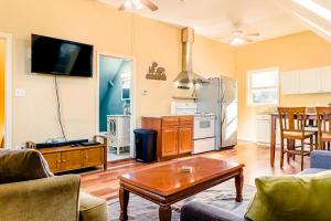 a living room with a couch and a table and a kitchen at Portland Urban Lodge, Quiet, Walkable, Near in Portland