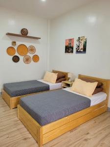 two twin beds in a room with at CAP Apartments in Talibon