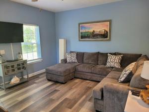 a living room with a couch and a flat screen tv at McDrifty's Getaway in Panama City Beach