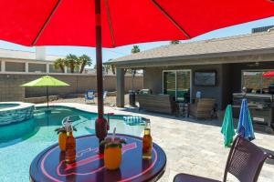 a table with drinks on it next to a pool at Coral Beauty! Heated Pool & Spa! in Lake Havasu City