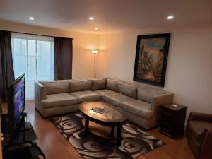a living room with a couch and a table at Beautiful Spacious 2 Bedroom, 2 Bathroom Condo in Long Beach