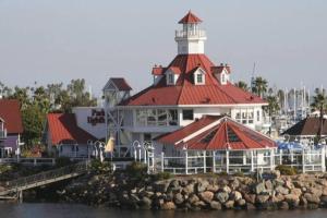 a large white building with a lighthouse on the water at Beautiful Spacious 2 Bedroom, 2 Bathroom Condo in Long Beach
