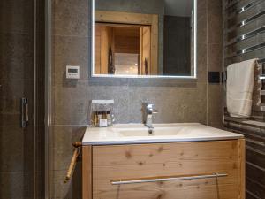 a bathroom with a sink and a mirror at Appartement de luxe à l'Alpe d'Huez, sur les pistes, terrasses, parking, 175m² pour 8 personnes - FR-1-645-37 in LʼHuez +9 photos