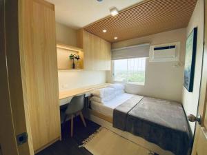 a bedroom with a bed and a desk and a window at Riverview Two Bedroom Condo at One Spatial Iloilo in Iloilo City +22 photos