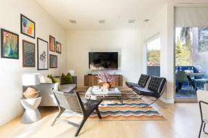 a living room with a couch and chairs and a tv at TuCasa Luxury 4 Story Villa in Downtown San Diego Little Italy in San Diego