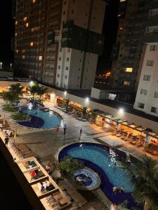 an overhead view of two pools in a city at night at Olímpia Park Resort - Apto 2 Quartos 8 Pessoas in Olímpia