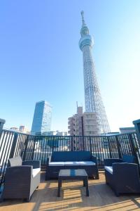 a rooftop deck with a view of the eiffel tower at THE BONDS HOTEL TOKYO in Tokyo