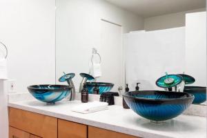 a bathroom with two blue sinks on a counter at TuCasa Luxury 4 Story Villa in Downtown San Diego Little Italy in San Diego +22 photos