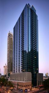 a tall building with many windows in a city at Stunning 2-Bedroom Oasis in the Heart of Southbank in Melbourne