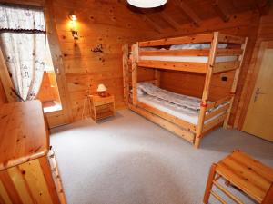 a bedroom with two bunk beds in a log cabin at Chalet Les Gets, 5 pièces, 9 personnes - FR-1-623-51 in Les Gets