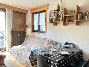 a living room with a table and a couch at Appartement Les Gets, 2 pièces, 4 personnes - FR-1-623-256 in Les Gets