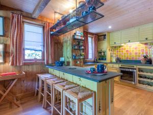 a kitchen with wooden walls and a large island with bar stools at Appartement Modane, 5 pièces, 8 personnes - FR-1-694-329 in Modane