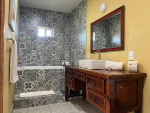 a bathroom with a sink and a mirror and a tub at Casa Belisario - Pet Friendly in Mazatlán +39 photos