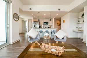 a kitchen and living room with two chairs and a table at Corporate Uptown Furnished Apartments in Charlotte