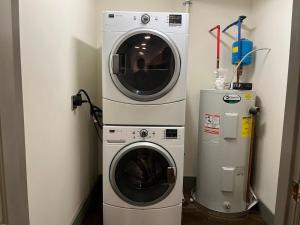 a washing machine and a washer in a room at Luxury 2 Bedroom Apt With Exposed Brick Downtown in Roanoke