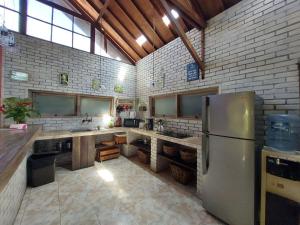 a large kitchen with a stainless steel refrigerator at Ocean Star Villa Five near the KuDeTa Beach in Seminyak