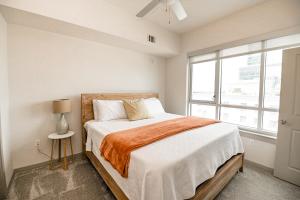 a bedroom with a large bed and a window at Corporate Uptown Furnished Apartments in Charlotte
