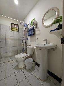 a bathroom with a toilet and a sink at Iguana Street Houses in Coco