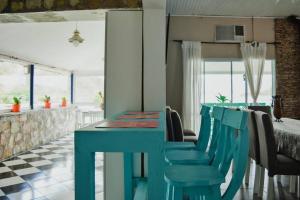 a dining room with a blue table and chairs at Casa Cabra Corral in Coronel Moldes