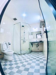 a bathroom with a toilet and a glass shower at Aloha Bình Tiên-Thôn Bình Tiên, Công Hải, Thuận Bắc, Ninh Thuận, Việt Nam in Phan Rang