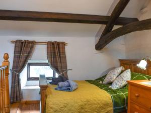 a bedroom with a bed and a window at Swinside Cottage in Ennerdale Bridge