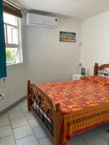 a bedroom with a bed with a quilt on it at Ti La Caze in Pereybere +51 photos